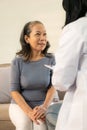 Asian female doctor talking about prescribing medicine to senior elderly patient Asian woman Royalty Free Stock Photo
