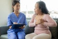 Asian female doctor talks to patient with smile to encourage patient at hospital An elderly