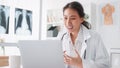 Asian female doctor using laptop computer online video call remote talking to patient Royalty Free Stock Photo