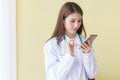 Asian female doctor Using a mobile phone Royalty Free Stock Photo