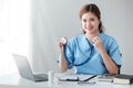 Asian female doctor working on laptop, filling out paperwork, patient medical history, reviewing documents at her Royalty Free Stock Photo