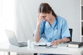 Asian female doctor working on laptop, filling out paperwork, patient medical history, reviewing documents at her Royalty Free Stock Photo