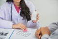 Asian female doctors talk to patients about symptoms and prescribe medication Royalty Free Stock Photo