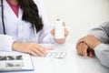 Asian female doctors talk to patients about symptoms and prescribe medication Royalty Free Stock Photo