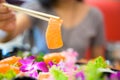 Asian female eating salmon sashimi, Japanese food style Royalty Free Stock Photo