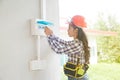 Asian female Electrician or Engineer check or Inspect Electrical system circuit Breaker. Royalty Free Stock Photo