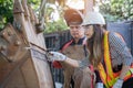 Asian female engineer checks workers` welds