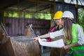 Asian female engineer checks workers welds