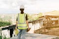 Asian female engineer Put on a white safety hat Wearing a green safety shirt Stand for construction inspection In the construction