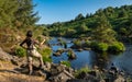 An asian female fly fisher women wearing waders, resting a rod on her shoulder Royalty Free Stock Photo