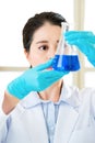 Asian female forensic scientist working on chemicals