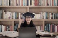 Asian female graduate has idea at library Royalty Free Stock Photo