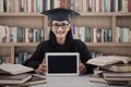 Asian female graduate show touchpad at library Royalty Free Stock Photo