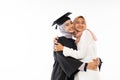 Asian female graduate student wearing toga hugging her sister