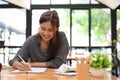 An asian female graphic designer sketching and designing her web design on blank paper Royalty Free Stock Photo