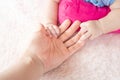 Asian Female hand holding  newborn baby hand. Mom with her child. Maternity, family, birth concept Royalty Free Stock Photo