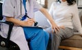 Asian female hands touching old female hand Helping hands holding bottle with pills in hands, reading instruction take care of the Royalty Free Stock Photo