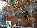 Asian female labour giving raw material pot to the worker on construction site in India January 2020 Royalty Free Stock Photo