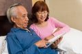 Asian female looking at tablet Royalty Free Stock Photo