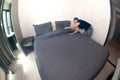 An Asian female maid making bed in hotel room. Housekeeper Making Bed. Royalty Free Stock Photo