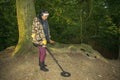 Asian Female Metal Detecting in Woodland Forest