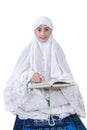 Asian female muslim reading Kuran - isolated Royalty Free Stock Photo