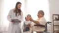 Asian female nurse tells how to take medicine to elderly senior grandfather patient Royalty Free Stock Photo