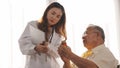 Asian female nurse tells how to take medicine to elderly senior grandfather patient Royalty Free Stock Photo