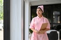 Asian female nurse in a uniform with medical clipboard stands in the hospital hallway Royalty Free Stock Photo