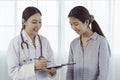 Asian female obstetrician talking to a patient about the illness to find a cure. Royalty Free Stock Photo