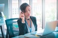 Female operator is talking on the phone to service client in the telemarkerting office Royalty Free Stock Photo