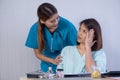 Asian Female Patient Being Reassured By Woman Doctor