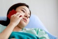 Asian female patient getting sick and lying on bed in hospital with unhappy and unwell condition while talking or communicating on Royalty Free Stock Photo