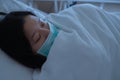 Asian female patient sleeping on hospital bed to recovering sickness, healthcare and medical concept - image Royalty Free Stock Photo