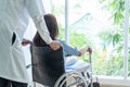 female patient on wheelchair with senior doctor