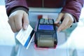 Woman hand with credit card swipe through terminal for sale Royalty Free Stock Photo