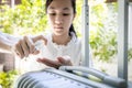 Asian female people with hand sanitizer spray and luggage,child girl is spraying disinfectant alcohol on her hands,hygiene,health Royalty Free Stock Photo