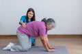 Asian female physical therapist doing back and lumbar physical therapy for an elderly woman. Royalty Free Stock Photo