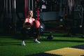 Asian female sportswear client exercise with kettlebells in gym Royalty Free Stock Photo