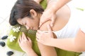 Asian female receiving back massage in spa Royalty Free Stock Photo