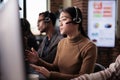 Asian female receptionist working at customer service helpdesk Royalty Free Stock Photo