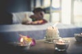 Asian female relaxing in Thai Spa with flower and hot compressed anc candle