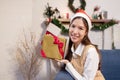 Asian Female with Santa Hat Hold Chrismas Gift Box with Smiling Face on Xmas New Year Party Royalty Free Stock Photo
