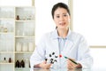 Asian female scientist teacher point at molecular model explain Royalty Free Stock Photo