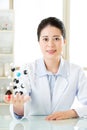Asian female scientist teacher point at molecular model explain Royalty Free Stock Photo