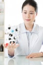 Asian female scientist teacher point at molecular model explain Royalty Free Stock Photo