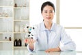 Asian female scientist teacher point at molecular model explain Royalty Free Stock Photo