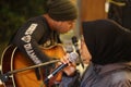 Asian female singer wearing a black veil with guitaris man