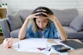 Asian female sitting expression face stressed by calculate expense on table from invoice or bill. She had financial and cost of Royalty Free Stock Photo