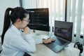 Asian female software developer is worried about analyzing code-based systems at his office